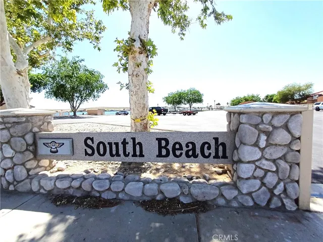 a view of a chairs and table in the back yard of the house