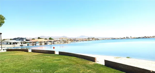 a view of a lake with houses in the back