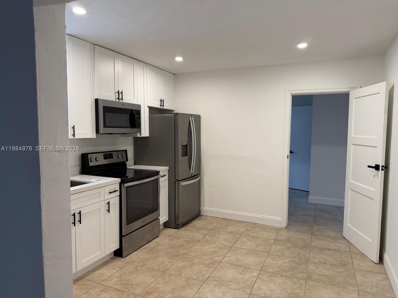2335 Northwest 68th Street, Unit 1 Miami, FL 33147 - Photo 12 of 12 a kitchen with a sink a stove and refrigerator
