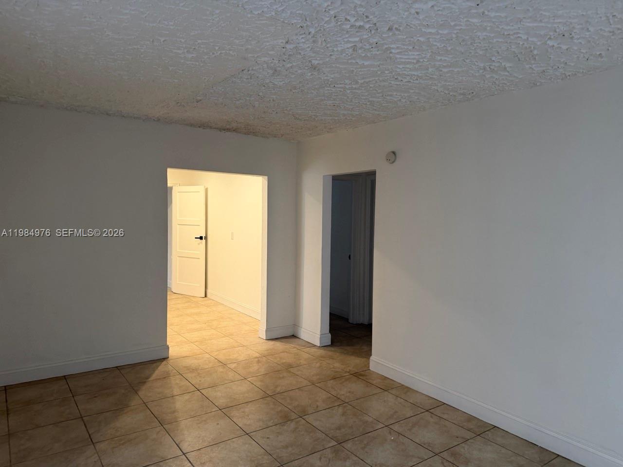 2335 Northwest 68th Street, Unit 1 Miami, FL 33147 - Photo 3 of 12 a view of an empty room and window