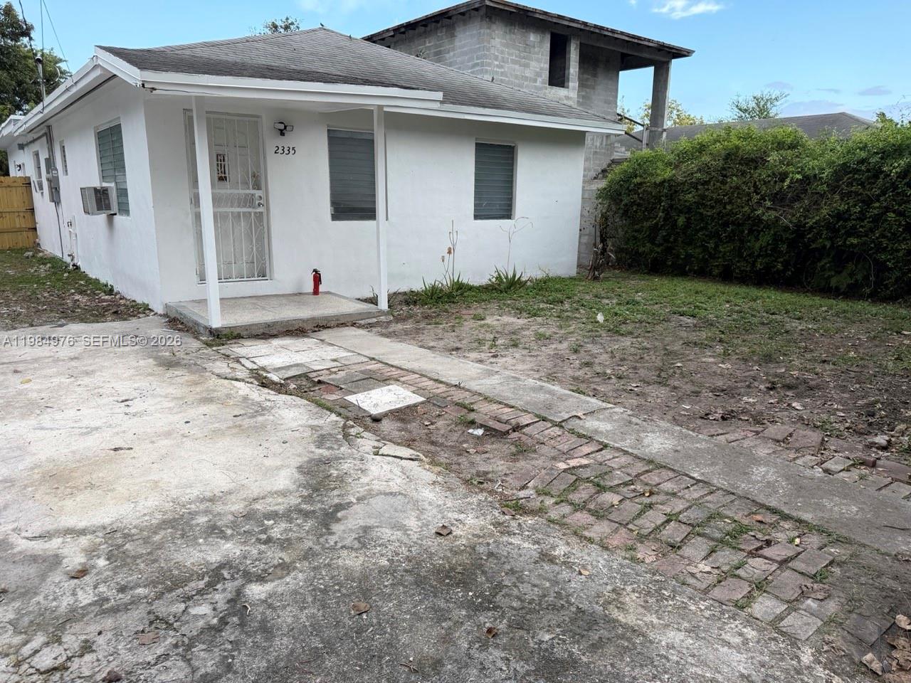 2335 Northwest 68th Street, Unit 1 Miami, FL 33147 - Photo 7 of 12 a view of a house with a yard