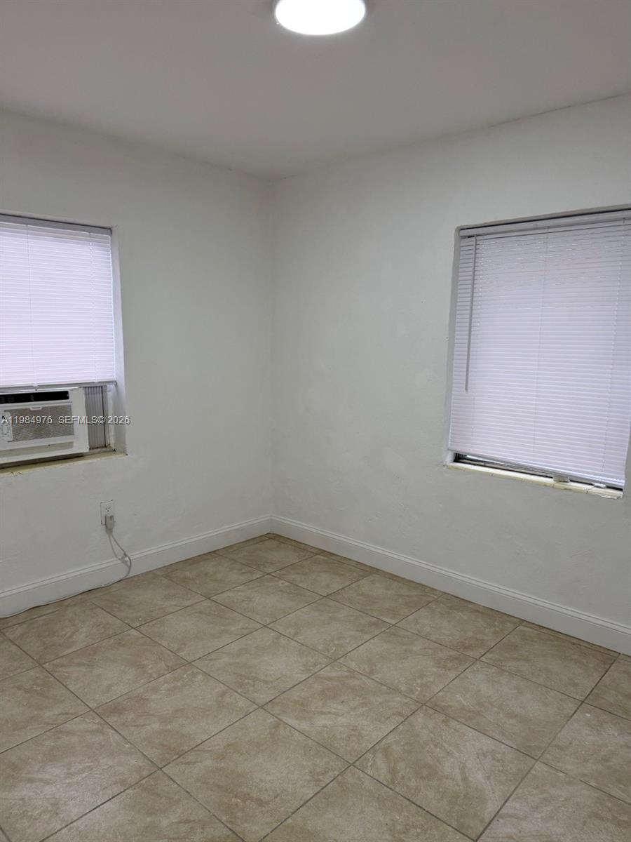 2335 Northwest 68th Street, Unit 1 Miami, FL 33147 - Photo 9 of 12 a view of an empty room with a window