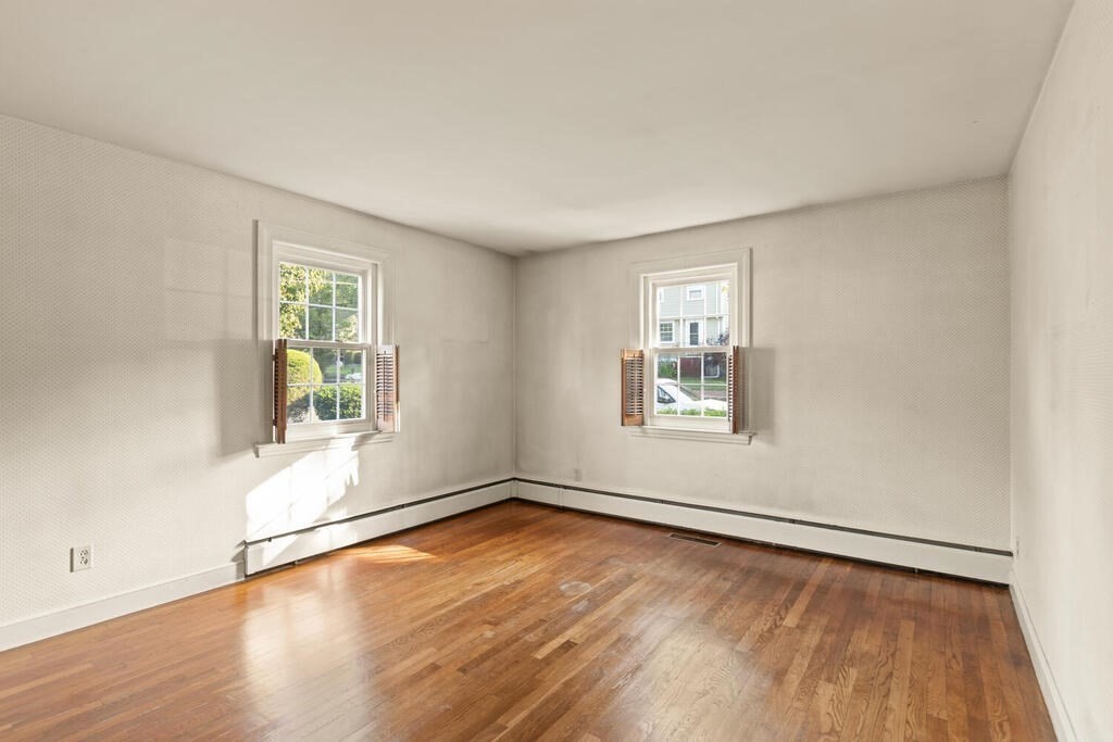 16 Surrey Road Salem, MA 01970 - Photo 23 of 32 an empty room with wooden floor and windows