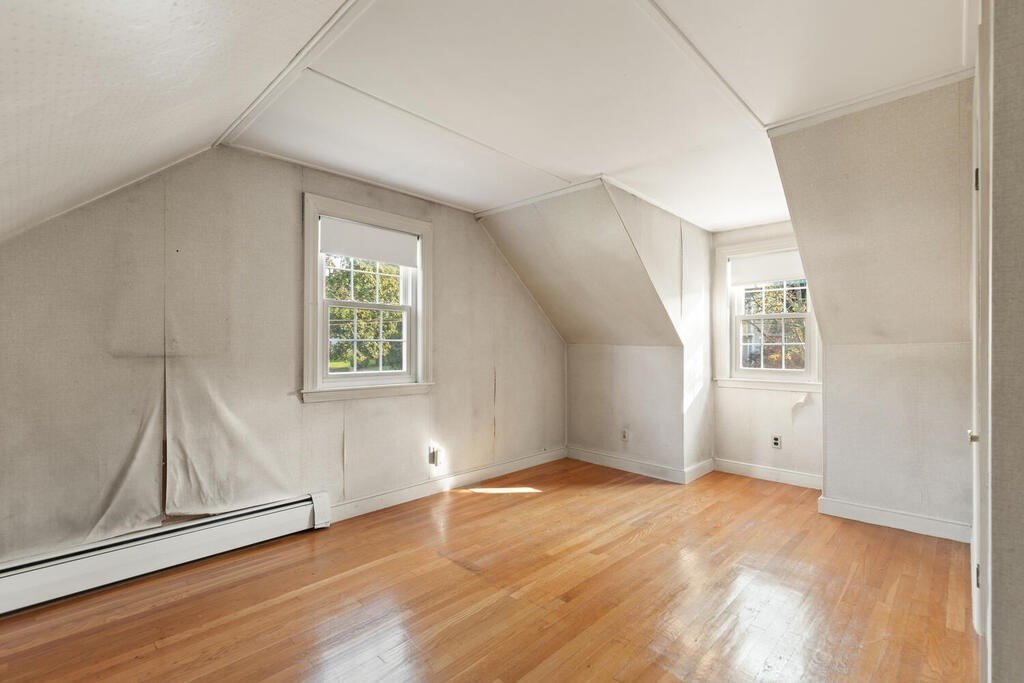 16 Surrey Road Salem, MA 01970 - Photo 27 of 32 an empty room with wooden floor and windows