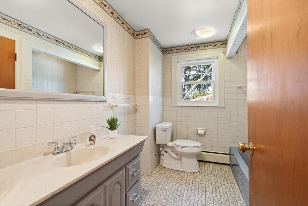 16 Surrey Road Salem, MA 01970 - Photo 29 of 32 a bathroom with a sink toilet a mirror and shower