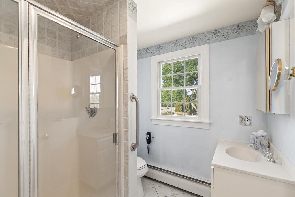 16 Surrey Road Salem, MA 01970 - Photo 30 of 32 a bathroom with a sink a mirror and a shower