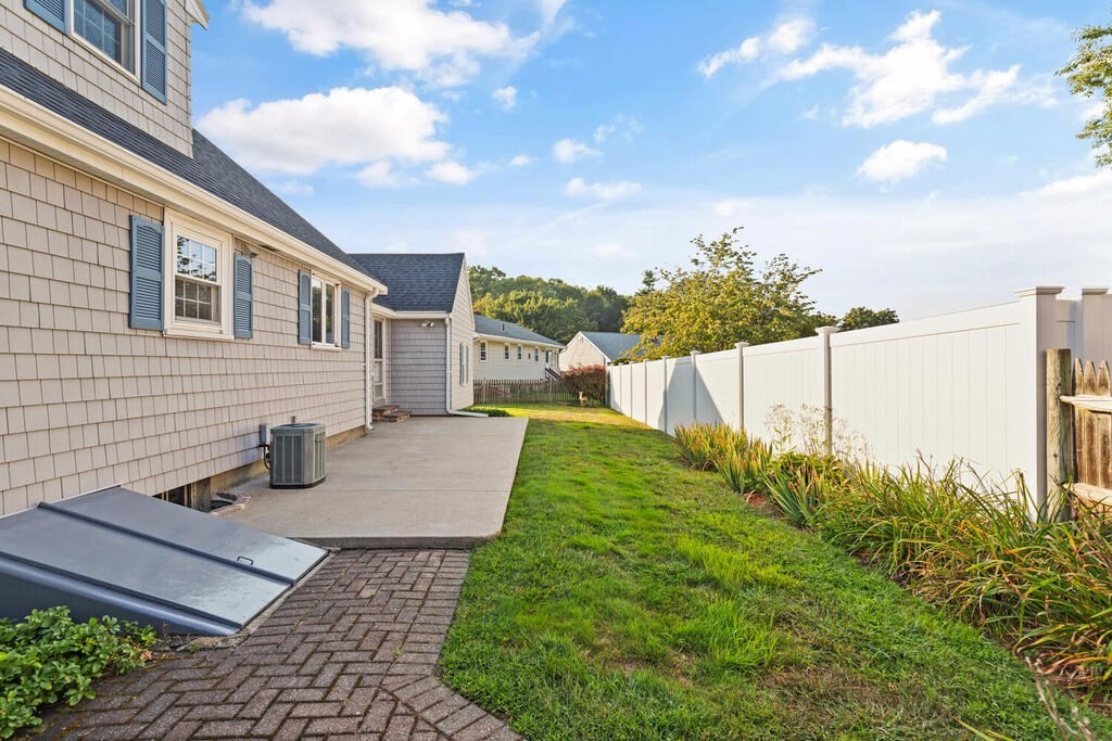 16 Surrey Road Salem, MA 01970 - Photo 32 of 32 a view of a patio with table and chairs and wooden fence