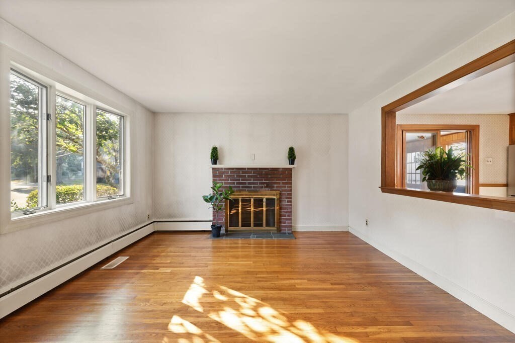 16 Surrey Road Salem, MA 01970 - Photo 5 of 32 a view of empty room with wooden floor and fireplace