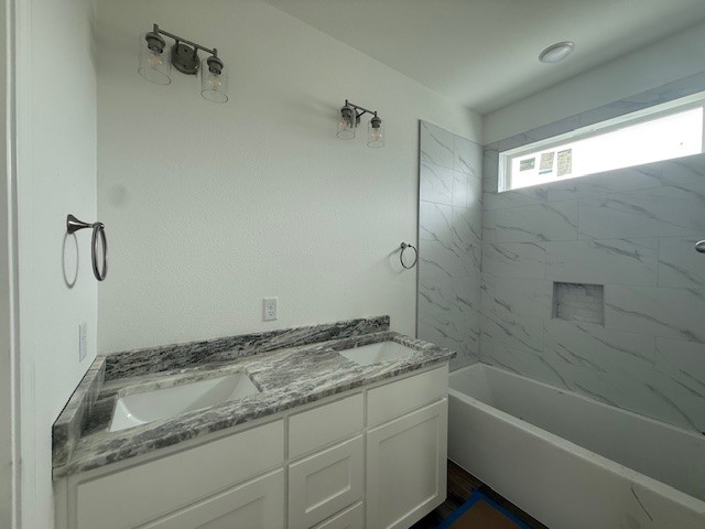 2607 Falcon Ridge Drive Bryan, TX 77803 - Photo 8 of 8 a bathroom with a granite countertop sink a toilet and bathtub