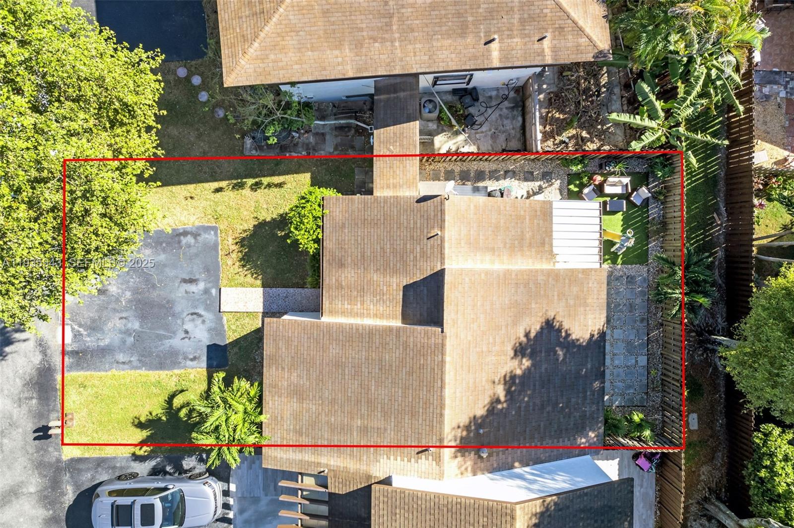 12950 Southwest 66th Terrace, Unit 12950 Miami, FL 33183 - Photo 13 of 16 an aerial view of a house with a yard and large trees