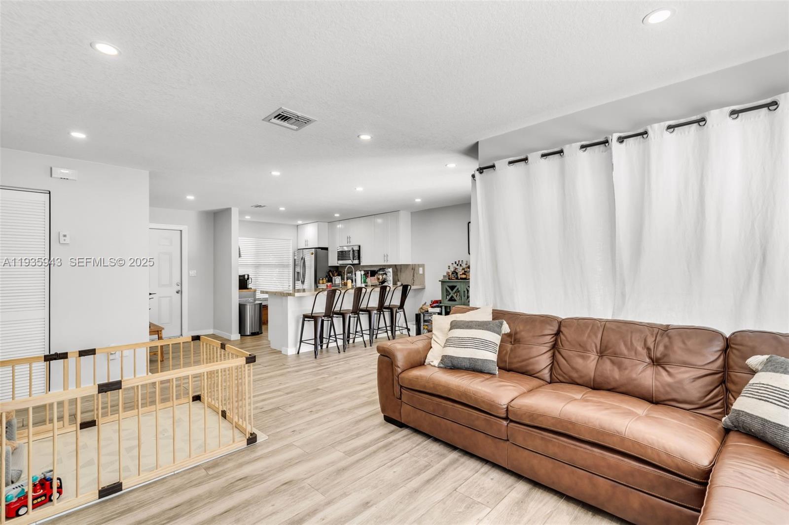 12950 Southwest 66th Terrace, Unit 12950 Miami, FL 33183 - Photo 4 of 16 a living room with furniture and a large window
