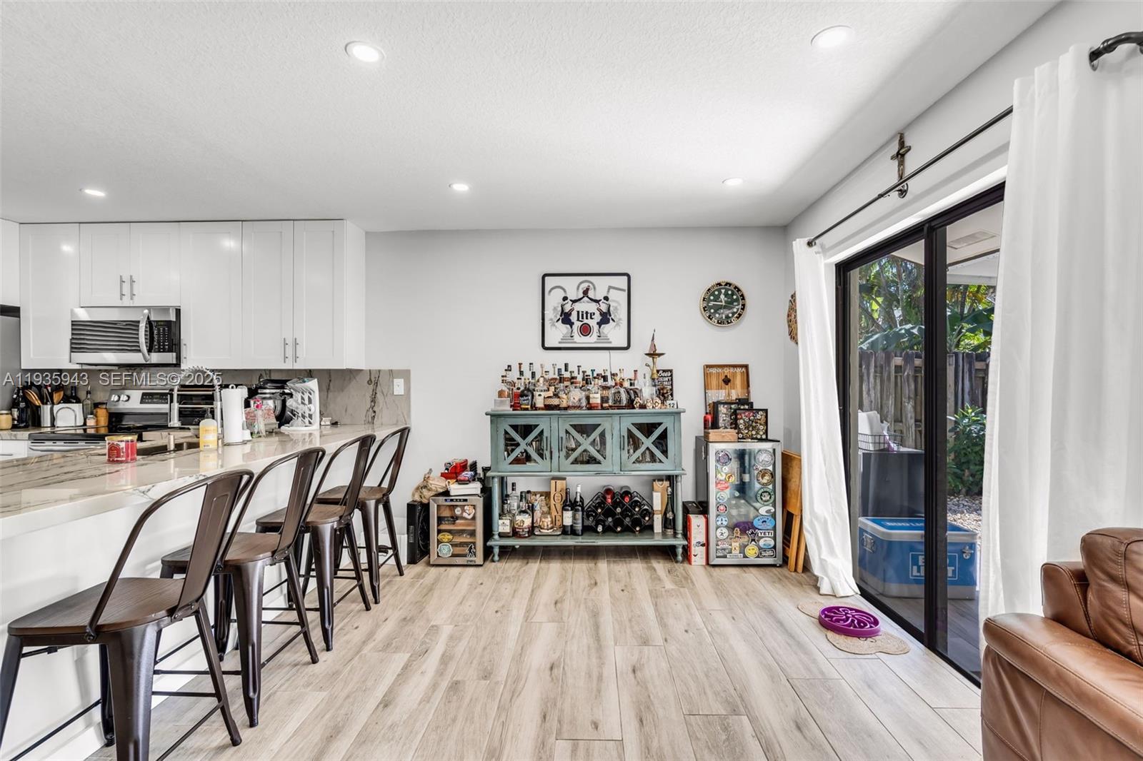 12950 Southwest 66th Terrace, Unit 12950 Miami, FL 33183 - Photo 5 of 16 a living room with furniture and a flat screen tv