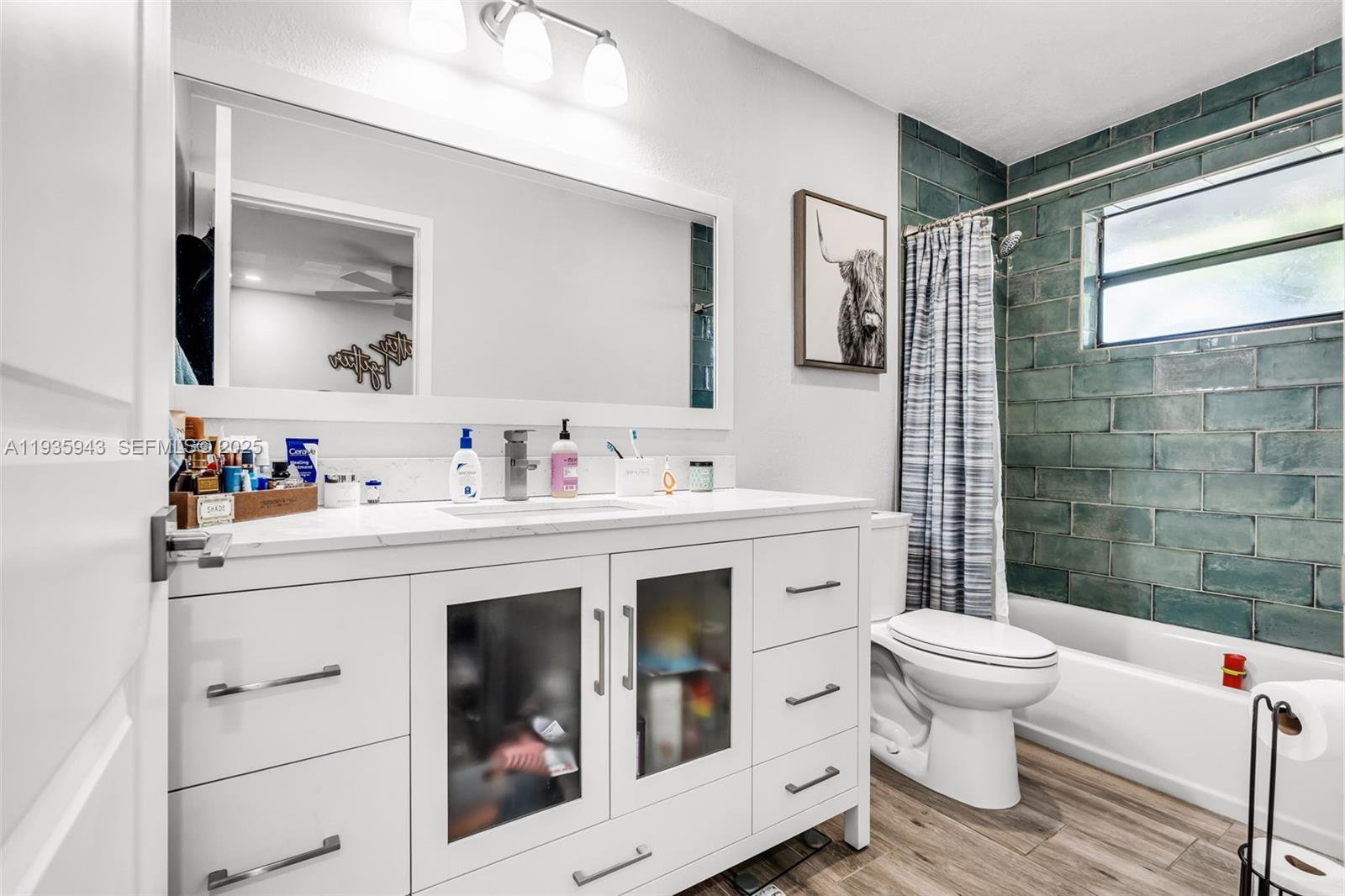 12950 Southwest 66th Terrace, Unit 12950 Miami, FL 33183 - Photo 8 of 16 a bathroom with a sink toilet and shower