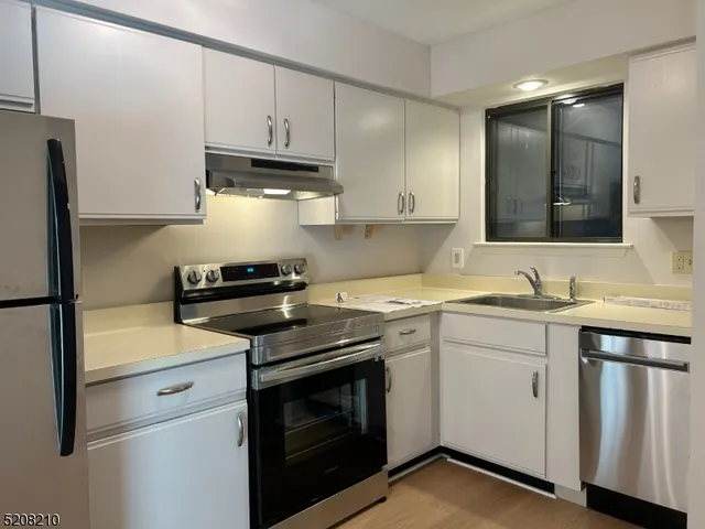 a kitchen with appliances cabinets and a sink