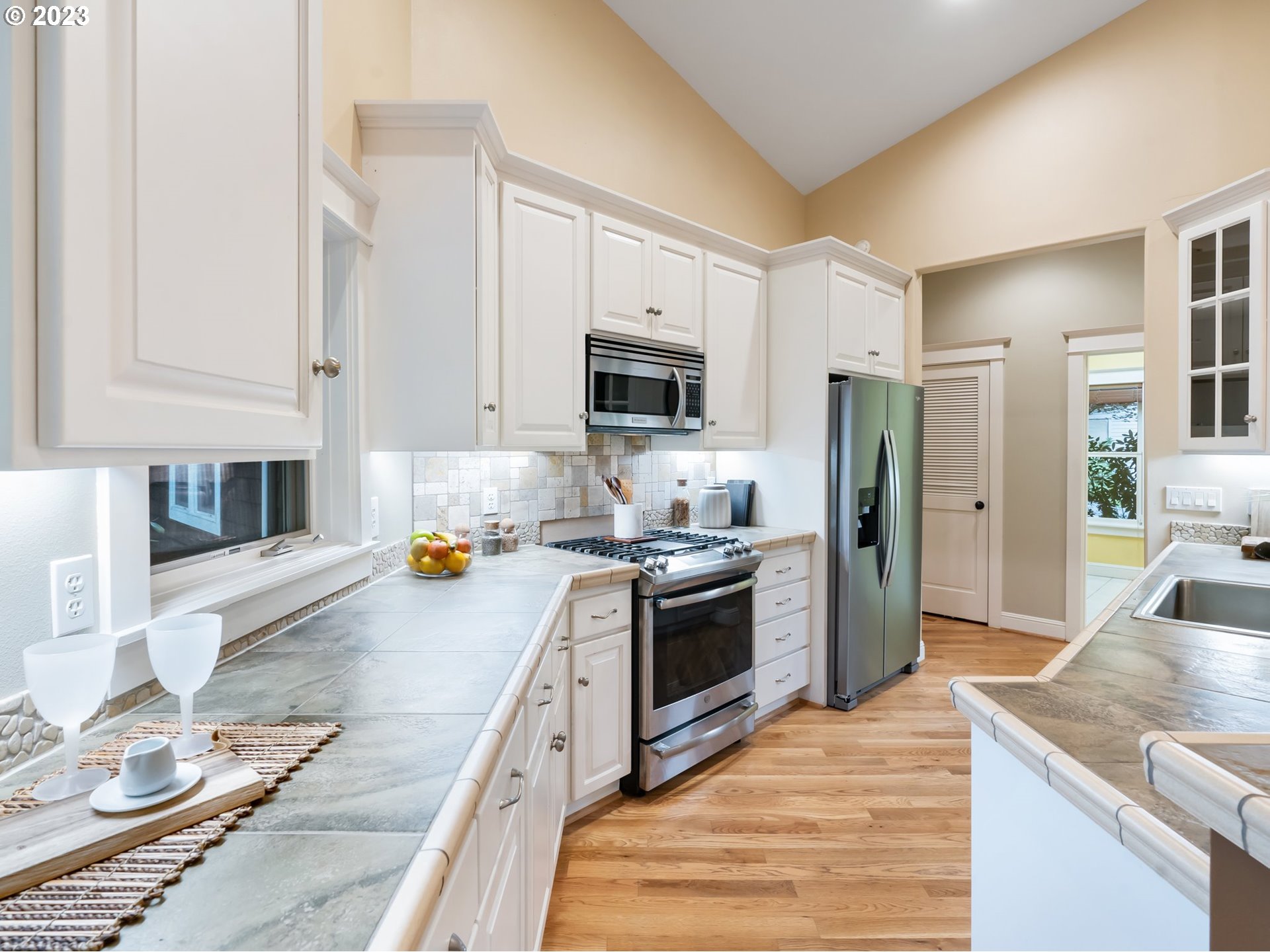 4410 West Burnside Road Portland, OR 97210 - Photo 12 of 42 a kitchen with stainless steel appliances granite countertop a stove top oven a refrigerator a sink and dishwasher
