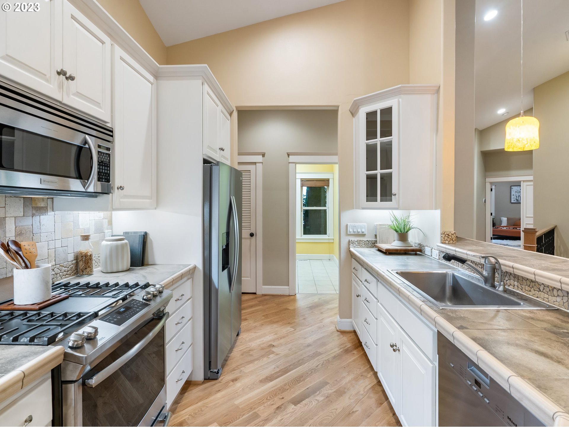 4410 West Burnside Road Portland, OR 97210 - Photo 13 of 42 a kitchen with stainless steel appliances granite countertop a sink stove and refrigerator