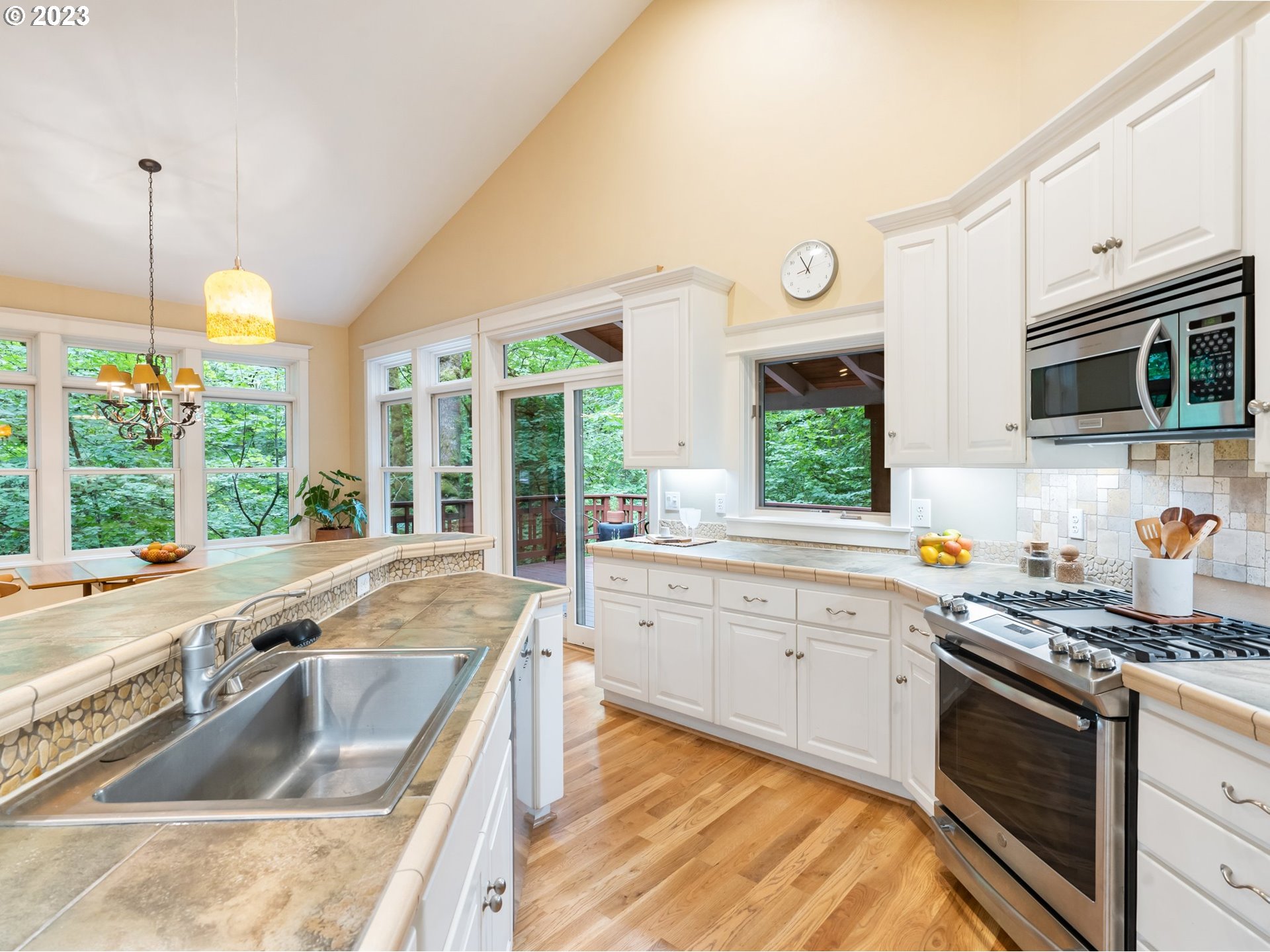 4410 West Burnside Road Portland, OR 97210 - Photo 14 of 42 a kitchen with stainless steel appliances granite countertop a sink and a stove