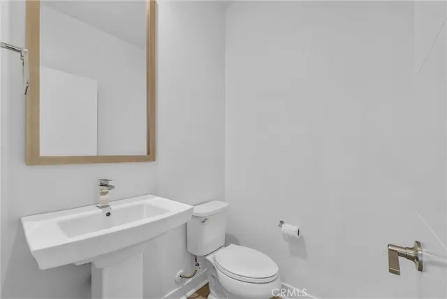 a bathroom with a sink a toilet and mirror