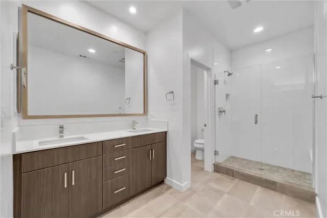 a spacious bathroom with a double vanity sink mirror and double