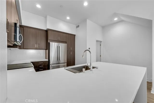 a kitchen with stainless steel appliances a refrigerator and a stove