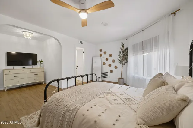 a spacious bedroom with a bed and a window