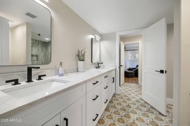 a bedroom with a bed tv and a window