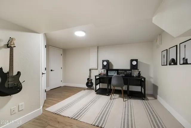 a bedroom with a bed and wooden floor