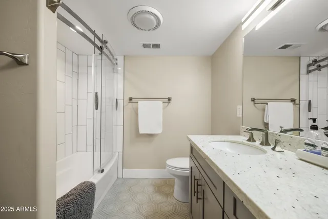 a bedroom with furniture and a flat screen tv