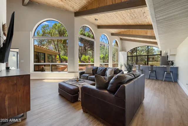 a large white kitchen with a stove top oven a sink dishwasher and a refrigerator with wooden floor