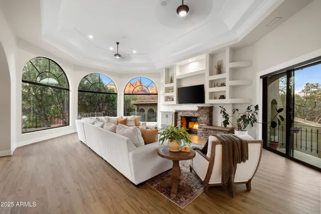 a view of a hallway with wooden floor and a chandelier