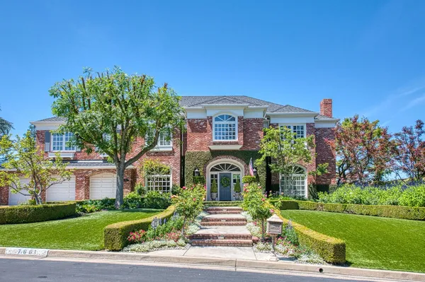 a front view of a house with garden