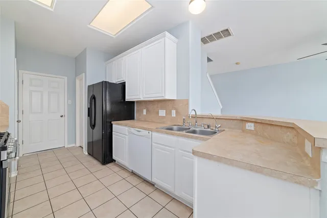 a kitchen with stainless steel appliances granite countertop a refrigerator and a stove