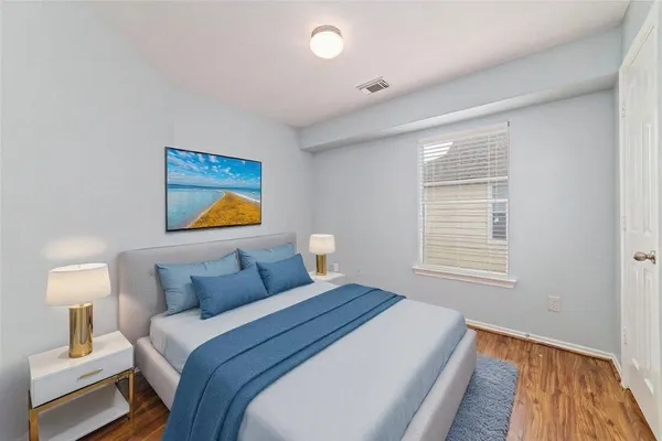 a bedroom with bed and night stand