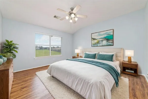 a bedroom with a large bed and a chandelier