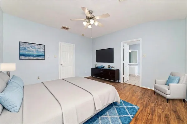 a bedroom with a bed and a flat screen tv