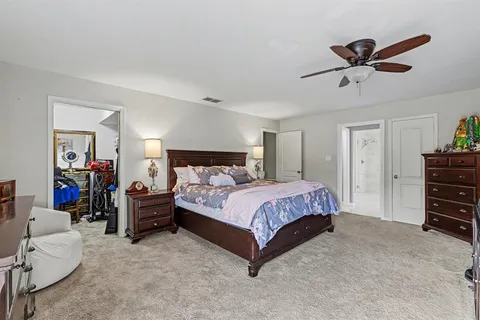 a bedroom with a bed and a ceiling fan