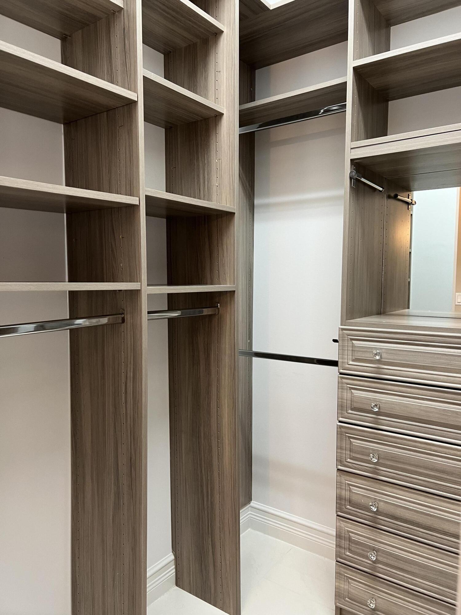 8375 Cloud Peak Drive Boynton Beach, FL 33473 - Photo 17 of 51 a view of walk in closet with empty racks
