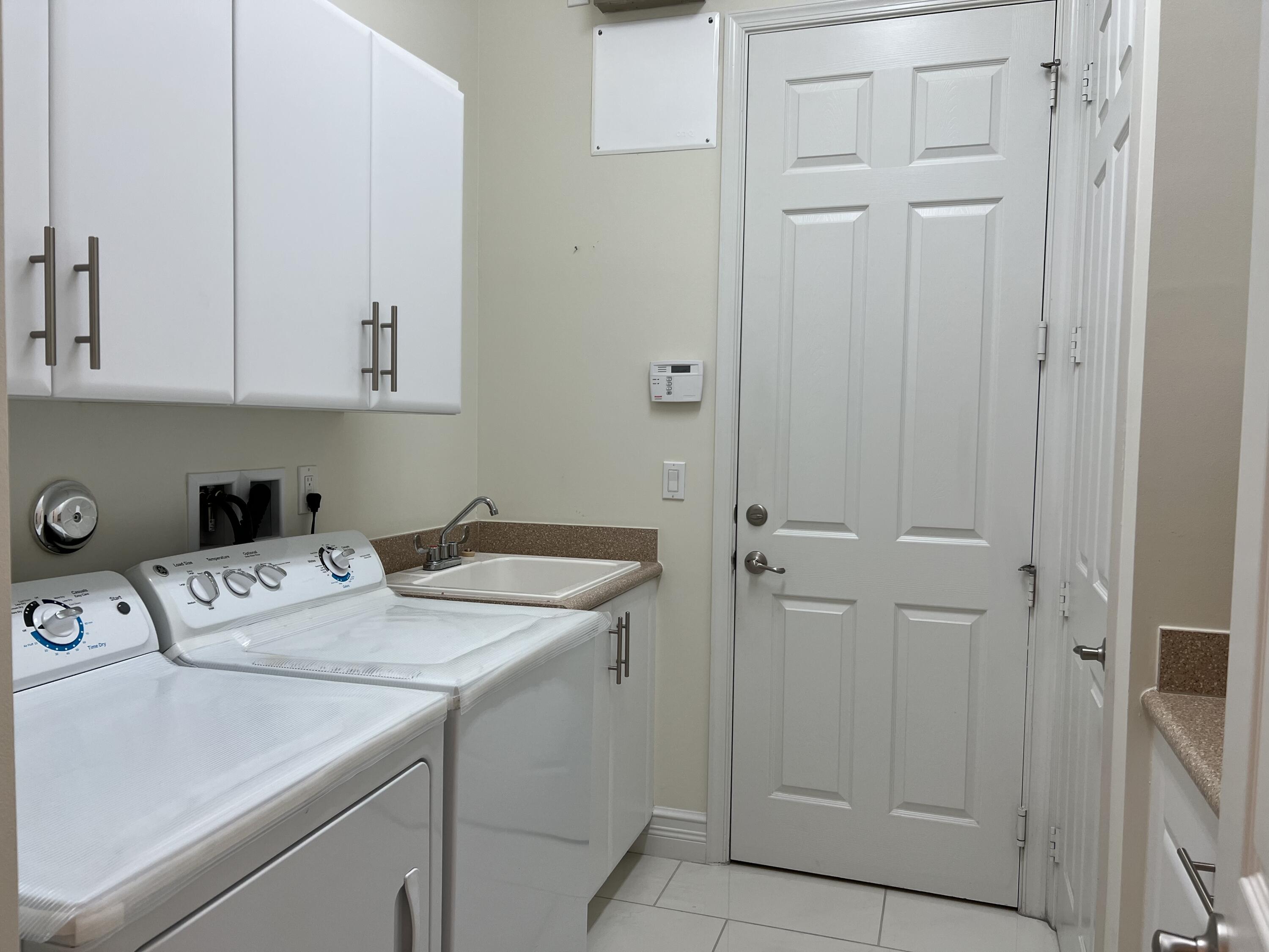 8375 Cloud Peak Drive Boynton Beach, FL 33473 - Photo 22 of 51 a room with storage and utility