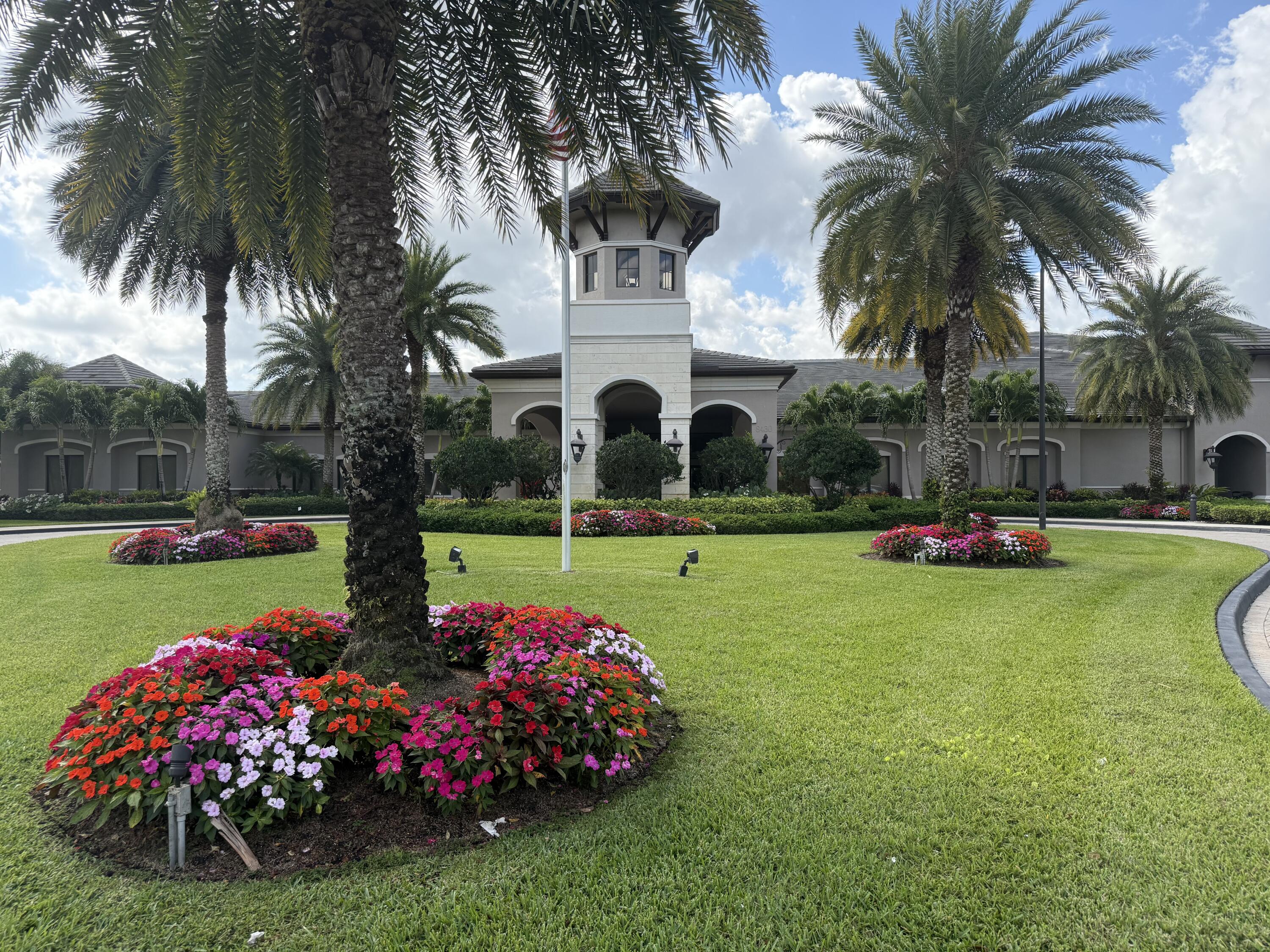 8375 Cloud Peak Drive Boynton Beach, FL 33473 - Photo 27 of 51 a front view of yellow and white house with a yard