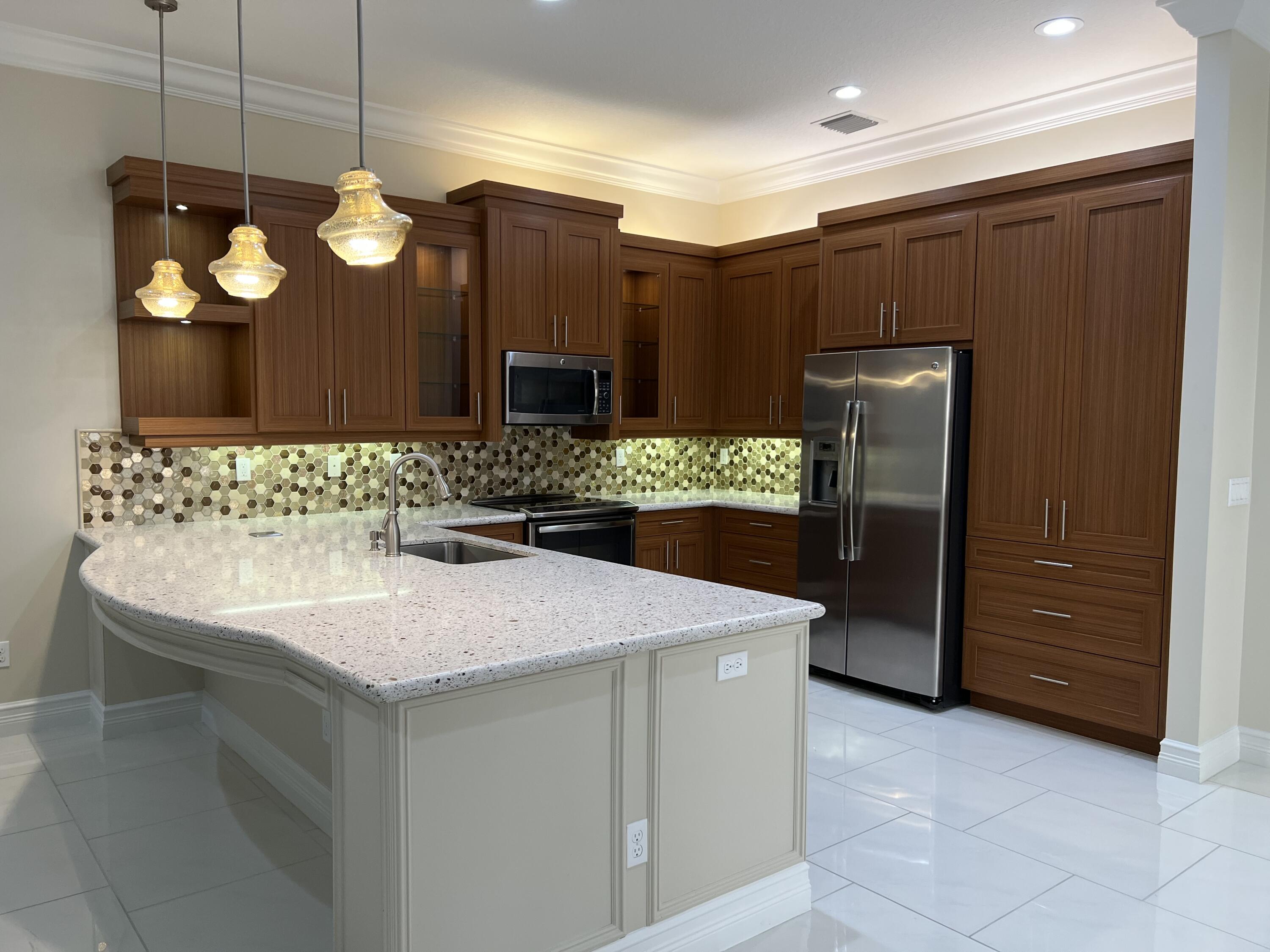 8375 Cloud Peak Drive Boynton Beach, FL 33473 - Photo 4 of 51 a kitchen with stainless steel appliances granite countertop a sink and a refrigerator