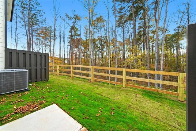 a view of a backyard with wooden fence