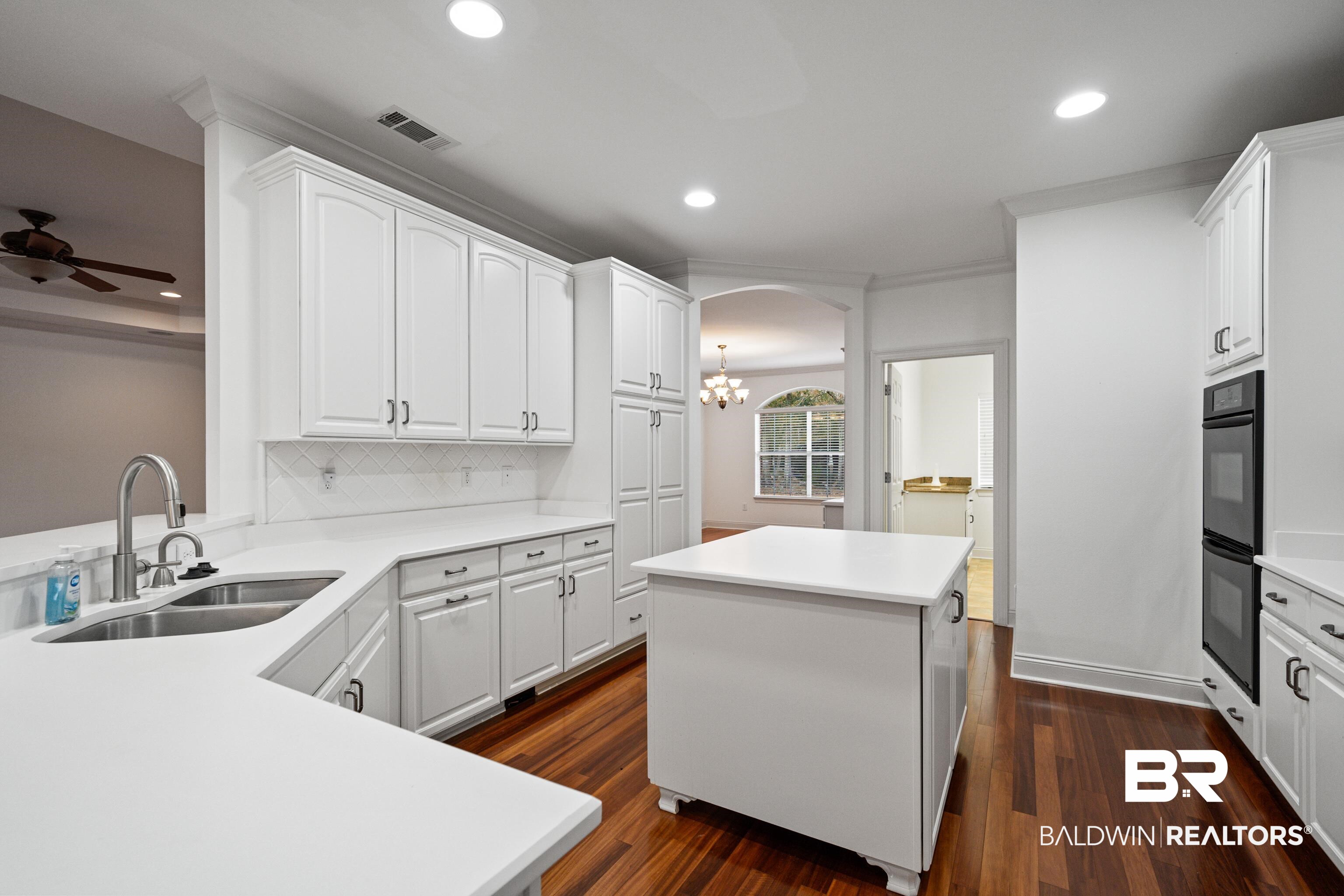 404 Savannah Lane Foley, AL 36535 - Photo 15 of 29 Kitchen with light countertops, a sink, visible vents, and white cabinets