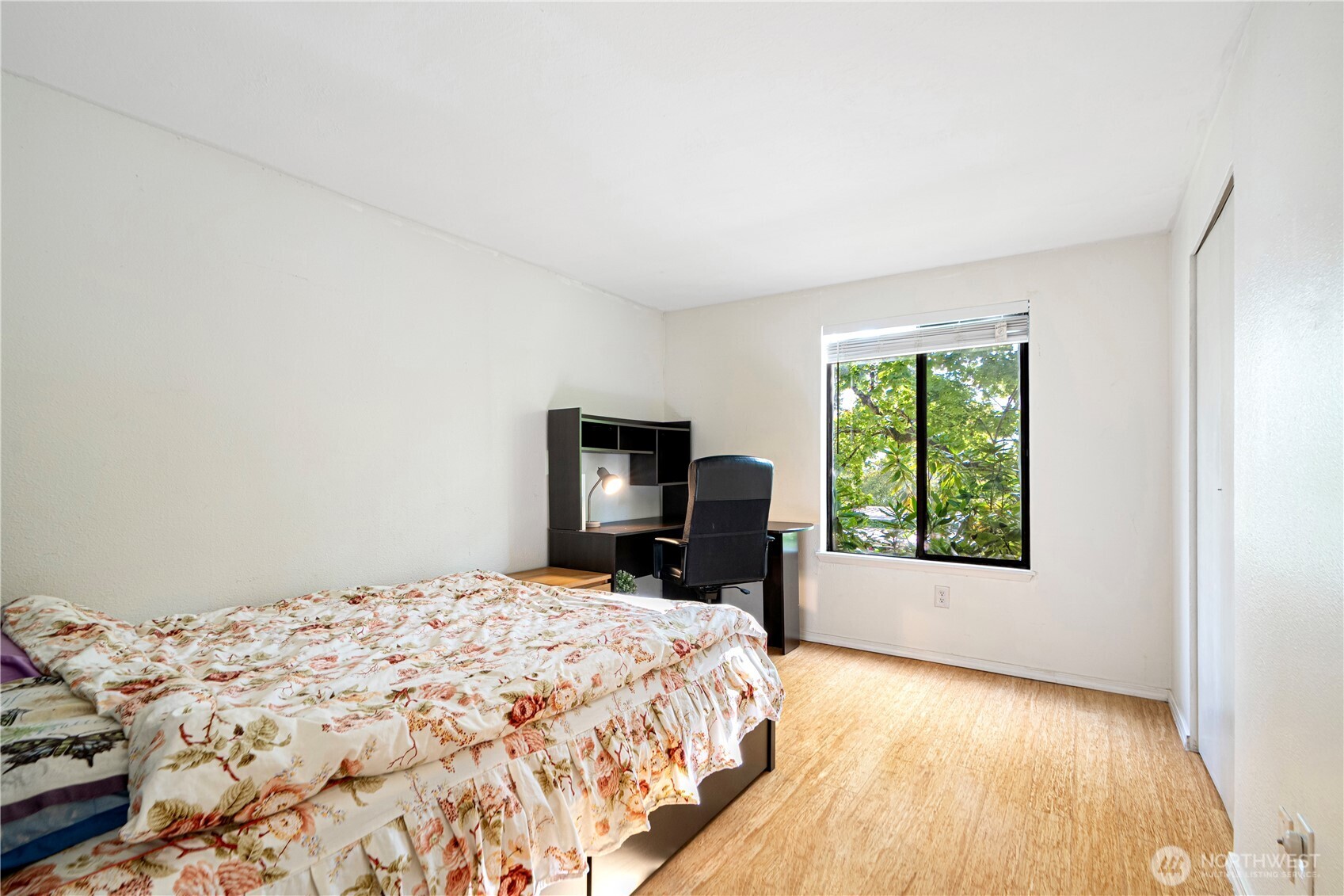 611 Southwest 5th Court, Unit A206 Renton, WA 98057 - Photo 17 of 21 a bedroom with a bed and wooden floor