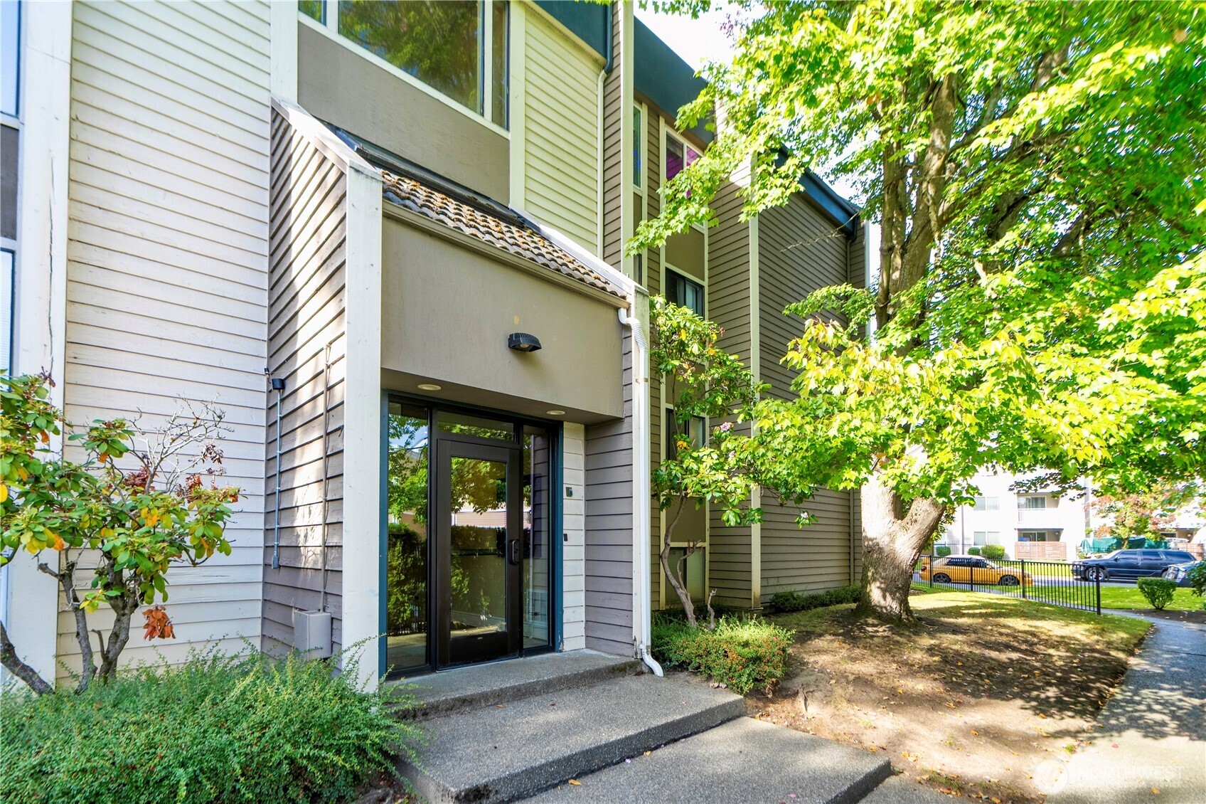 611 Southwest 5th Court, Unit A206 Renton, WA 98057 - Photo 2 of 21 a front view of a house with a yard