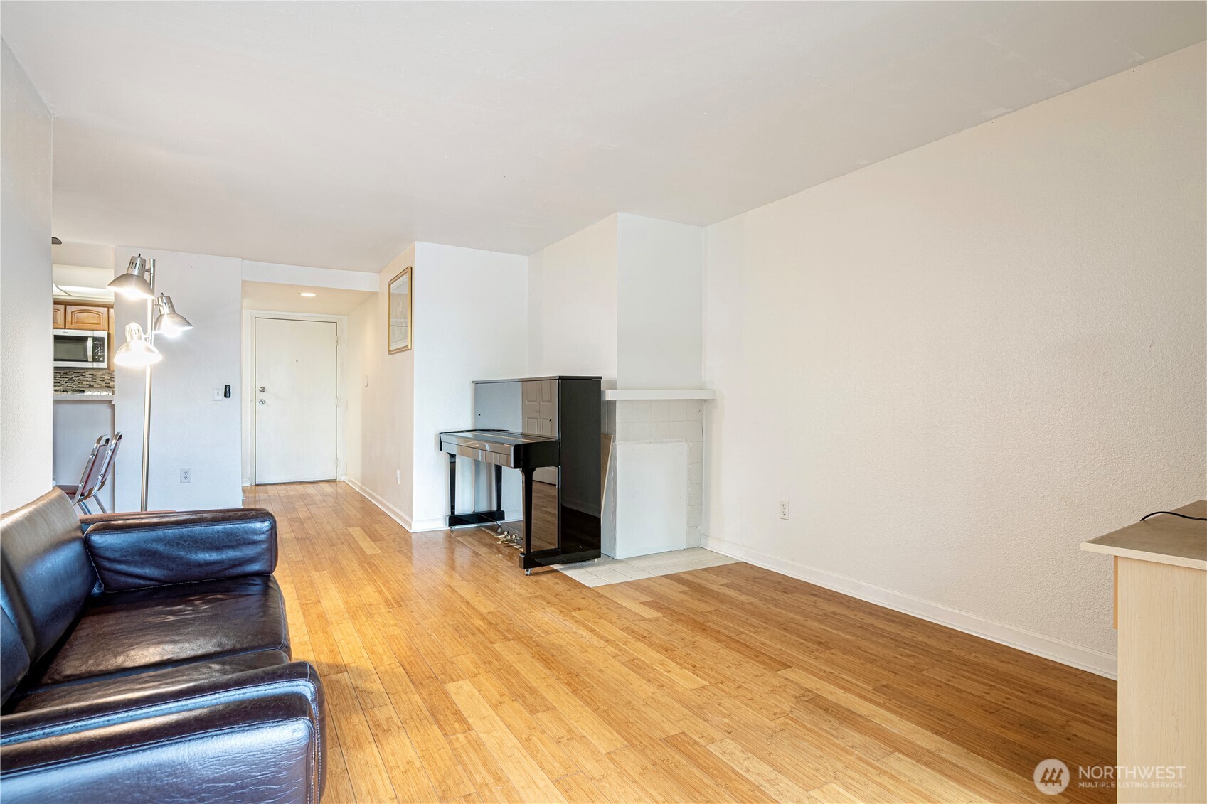 611 Southwest 5th Court, Unit A206 Renton, WA 98057 - Photo 9 of 21 a bedroom with a bed and a view of kitchen
