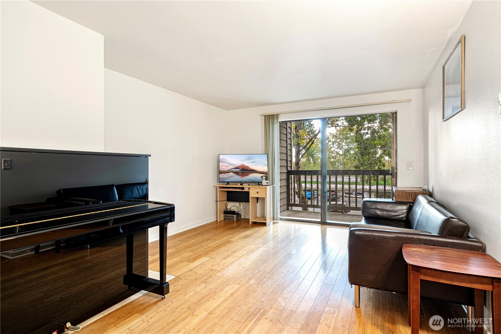 611 Southwest 5th Court, Unit A206 Renton, WA 98057 - Photo 10 of 21 a living room with furniture a fireplace and a flat screen tv