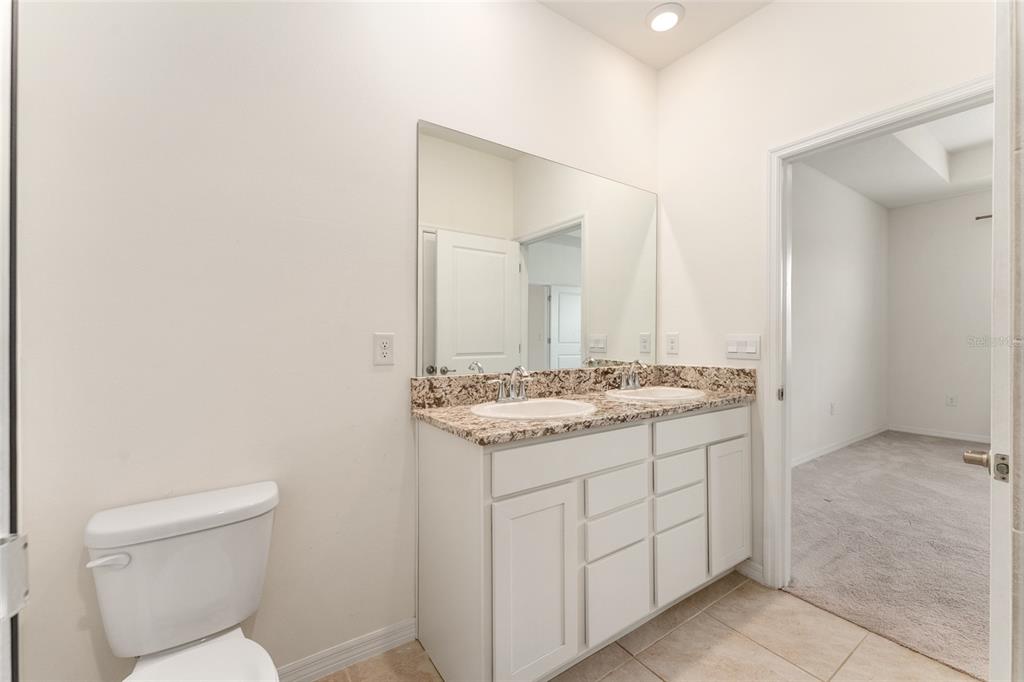 5347 Northwest 46th Lane Road Ocala, FL 34482 - Photo 25 of 79 a bathroom with a granite countertop sink and a toilet