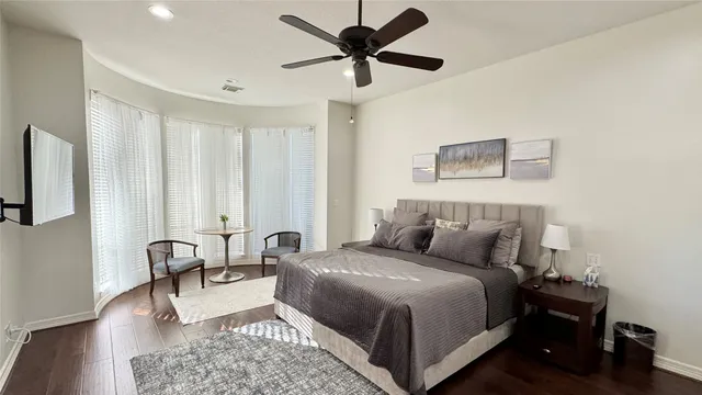 a spacious bathroom with a granite countertop sink a mirror and shower