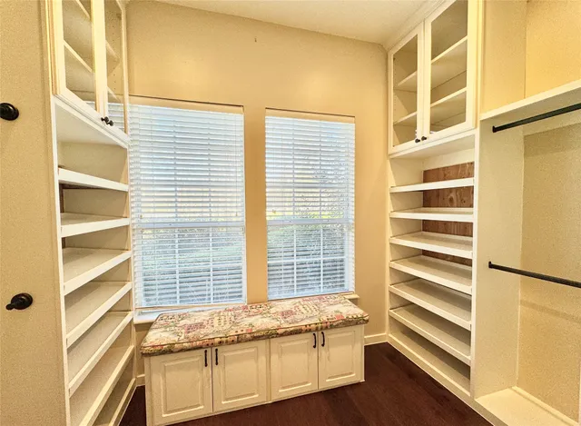 a kitchen with granite countertop a sink stainless steel appliances and white cabinets