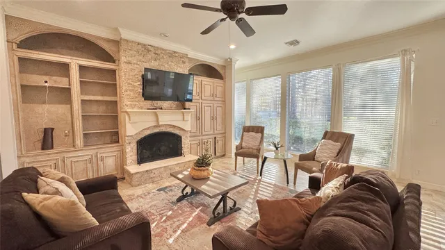 a living room with furniture and a floor to ceiling window